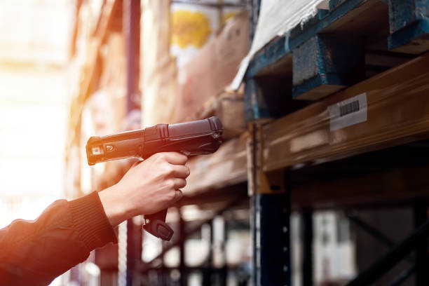 Warehouse worker is using a barcode scanner