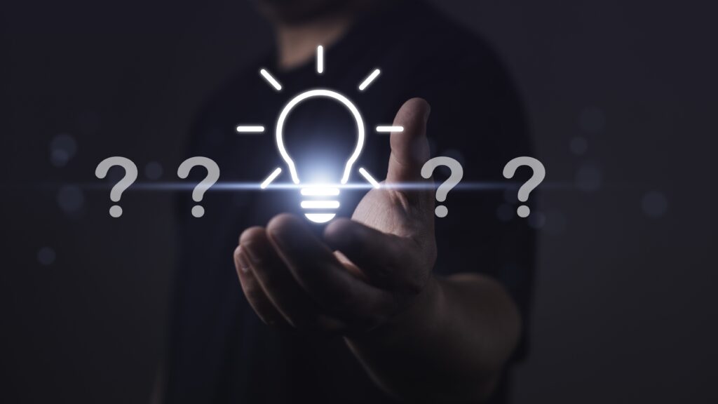 Light bulb surrounded by question marks